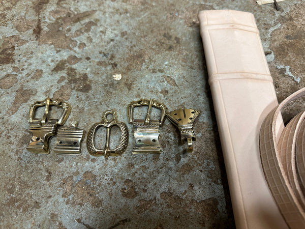 Close up of top half of scabbard with associated belts and metalwork