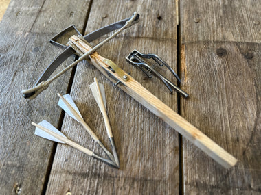 mini 15th century medieval crossbow with lashed bow, goats foot lever and 3 mini feather-fletched bolts.  view from above.  50lb draw weight.