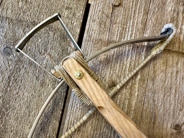 mini 15th century medieval crossbow with lashed bow.  view of stirrup close-up.  